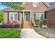 Close-up of a brick front porch with decorative plants and a stylish front door at 3011 Patrick Place Cir, Clover, SC 29710