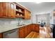 Kitchen boasts granite countertops, wood cabinets, and stainless steel dishwasher, adjacent to the dining area at 3011 Patrick Place Cir, Clover, SC 29710