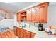 A kitchen with wooden cabinets, stainless steel appliances, granite countertops, and hardwood floors at 3011 Patrick Place Cir, Clover, SC 29710