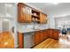 Kitchen with wooden cabinets, granite countertops, stainless steel dishwasher, and hardwood flooring at 3011 Patrick Place Cir, Clover, SC 29710