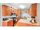 Functional kitchen featuring wood cabinets, stainless steel appliances, granite countertops, and bright overhead lighting at 3011 Patrick Place Cir, Clover, SC 29710