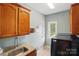 Efficient laundry room with granite counters, cabinets, and modern washer/dryer units at 3011 Patrick Place Cir, Clover, SC 29710