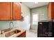 Well-lit laundry room features granite countertop, sink, and ample cabinet space near new washer and dryer at 3011 Patrick Place Cir, Clover, SC 29710