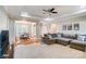 Open-concept living room flowing into dining area, complete with tray ceilings, hardwood floors, and neutral decor at 3011 Patrick Place Cir, Clover, SC 29710