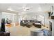 Bright living room with a large sectional, fireplace, and open access to the dining room at 3011 Patrick Place Cir, Clover, SC 29710