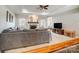 Comfortable living room featuring a stone fireplace, tray ceiling, large sectional sofa, and open layout at 3011 Patrick Place Cir, Clover, SC 29710