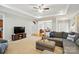 Cozy living room features a large sectional, fireplace, and a view into the dining room at 3011 Patrick Place Cir, Clover, SC 29710
