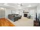 Inviting living room featuring a fireplace, large sectional, and tray ceiling with a ceiling fan at 3011 Patrick Place Cir, Clover, SC 29710