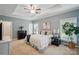 Spacious bedroom featuring tray ceiling, carpet, natural light, and stylish decor at 3011 Patrick Place Cir, Clover, SC 29710