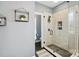 Modern shower with textured tile, glass enclosure, and a sleek black fixtures at 3011 Patrick Place Cir, Clover, SC 29710