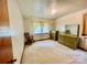 Comfortable bedroom with light pink walls, carpet flooring, and a rocking chair at 309 E Stevens Rd, Kershaw, SC 29067