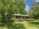 Charming single-story brick home with a well-maintained front yard and mature trees at 309 E Stevens Rd, Kershaw, SC 29067