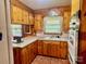 Cozy kitchen with wooden cabinets, white countertops, brick floors, and modern appliances at 309 E Stevens Rd, Kershaw, SC 29067
