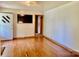 Bright living room featuring hardwood floors, a mounted TV, and fresh paint at 309 E Stevens Rd, Kershaw, SC 29067