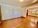 Open-concept living space with gleaming hardwood floors and neutral wall paint at 309 E Stevens Rd, Kershaw, SC 29067