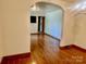 Inviting living room featuring gleaming hardwood floors and an archway to another room at 309 E Stevens Rd, Kershaw, SC 29067