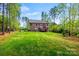 Spacious backyard featuring a well-maintained lawn, mature trees, patio, and a wooded area at 3095 Foggy Hollow Ln, Clover, SC 29710