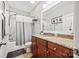 Bathroom featuring a granite countertop vanity with dark wood cabinets, and a shower-tub combo at 3095 Foggy Hollow Ln, Clover, SC 29710