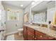 Bright bathroom with a granite countertop, wood cabinets, and a shower with a decorative curtain at 3095 Foggy Hollow Ln, Clover, SC 29710