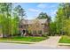 Spacious two-story brick home featuring a well-manicured lawn, mature trees, and a long driveway at 3095 Foggy Hollow Ln, Clover, SC 29710