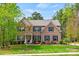 Traditional brick home with blue shutters, landscaped lawn, and mature trees, creating a welcoming curb appeal at 3095 Foggy Hollow Ln, Clover, SC 29710