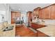 Spacious kitchen with stainless steel appliances, wood cabinets, granite countertops and a dining area beyond at 3095 Foggy Hollow Ln, Clover, SC 29710