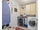 Modern laundry room with a front load washer and dryer, ample storage, and an ironing board at 3095 Foggy Hollow Ln, Clover, SC 29710