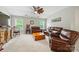 Spacious living room featuring brown leather couches, a wooden coffee table, and a unique ceiling fan at 3095 Foggy Hollow Ln, Clover, SC 29710