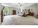 Bright main bedroom featuring a king bed, sitting bench, and large windows providing natural light at 3095 Foggy Hollow Ln, Clover, SC 29710
