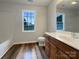 A bright bathroom features a vanity with storage, a window, and a tub with shower, offering functionality and comfort at 4147 Timberwood Dr, Gastonia, NC 28056