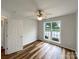This bedroom has wood-look floors, a ceiling fan, and a window to the backyard at 4147 Timberwood Dr, Gastonia, NC 28056