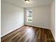An empty bedroom featuring a neutral color palette, hardwood floors, and a sunlit window at 4147 Timberwood Dr, Gastonia, NC 28056