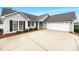 The house has a two car garage and a paved driveway at 4147 Timberwood Dr, Gastonia, NC 28056