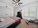 Neutral bedroom featuring a ceiling fan, double closets, and work out equipment at 4189 Brandy Creek Ct, Clover, SC 29710