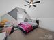 Attic bedroom featuring a modern bed and a window at 4189 Brandy Creek Ct, Clover, SC 29710