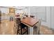 Open dining area featuring a wooden table, views into the bright kitchen, and hardwood floors at 4189 Brandy Creek Ct, Clover, SC 29710
