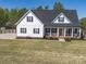 Charming white home featuring a welcoming front porch, black shutters, and a well-manicured lawn at 4189 Brandy Creek Ct, Clover, SC 29710
