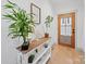 Entryway with a wood door, console table decorated with plants, and light hardwood flooring at 4189 Brandy Creek Ct, Clover, SC 29710