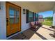Inviting front porch featuring rocking chairs, a wooden door, and stylish black shutters and lighting at 4189 Brandy Creek Ct, Clover, SC 29710