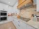 Bright kitchen featuring white cabinets, stainless steel appliances, a brick backsplash, and granite countertops at 4189 Brandy Creek Ct, Clover, SC 29710