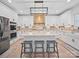 A large kitchen includes a kitchen island with barstool seating, modern lighting, and stainless steel appliances at 4189 Brandy Creek Ct, Clover, SC 29710
