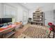 A well-lit office features hardwood floors, an orange desk and ample shelving for books at 4189 Brandy Creek Ct, Clover, SC 29710
