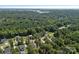Scenic aerial view of a community surrounded by lush green trees and a lake in the distance at 4195 Island Fox Ln, Denver, NC 28037