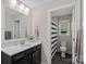Bathroom features a vanity with white countertop and a view into the toilet/shower area at 4195 Island Fox Ln, Denver, NC 28037