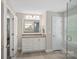 Neutral bathroom featuring a granite vanity and a framed mirror at 4195 Island Fox Ln, Denver, NC 28037