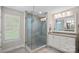Modern bathroom featuring a glass enclosed shower, tiled walls, and double vanity at 4195 Island Fox Ln, Denver, NC 28037