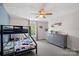 Bright bedroom featuring a bunk bed, ceiling fan, and gray dresser at 4195 Island Fox Ln, Denver, NC 28037