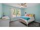 Bedroom with blue walls, a large window, and neutral decor at 4195 Island Fox Ln, Denver, NC 28037