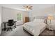 Bedroom featuring a desk area, ceiling fan, and queen sized bed at 4195 Island Fox Ln, Denver, NC 28037