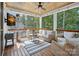 Relaxing covered patio with wicker furniture, ceiling fan, and wooded backyard views at 4195 Island Fox Ln, Denver, NC 28037